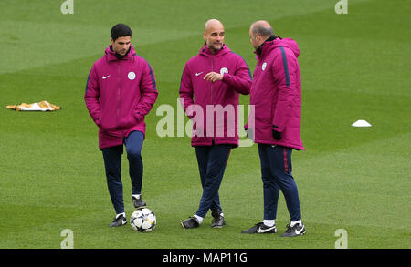 Manchester City manager Pep Guardiola speaks to his coaching staff during the training session at Anfield, Liverpool. Stock Photo