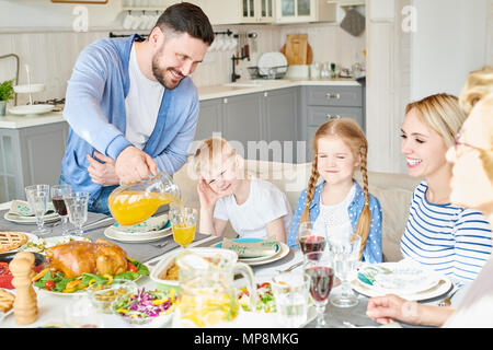 Happy Family at Dinner Table Stock Photo