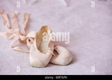 Small ballet shoes isolated on pink background Stock Photo