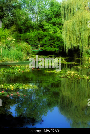 Photograph of Claude Monet's water-lily pond, showing foot bridge with lilies in the pond (which he painted), rendered in PS, Giverny, France Stock Photo