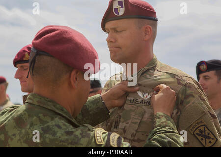 A Mexican Jumpmaster pins Mexican jump wings onto a South African ...