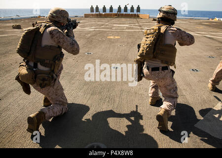 Marines assigned to Light Armored Reconnaissance Company, Battalion Landing Team, 3rd Battalion, 6th Marine Regiment, 24th Marine Expeditionary Unit (MEU), prepare to engage targets in the during a weapons proficiency live-fire training exercise aboard the amphibious transport dock ship USS Mesa Verde (LPD 19) May 10, 2017. The 24th MEU is underway with the Bataan Amphibious Ready Group in support of maritime security operations and theater security cooperation efforts in the U.S. 6th Fleet area of operations. Stock Photo