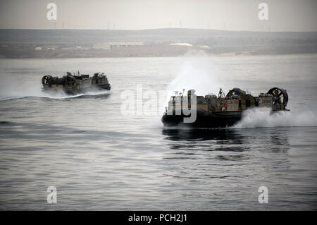 OCEAN (June 21, 2012) Landing craft air cushion approaches the welldeck of the amphibious assault ship USS Makin Island (LHD 8) to support an equipment offload. Makin Island and Marines assigned to the 11th Marine Expeditionary Unit are deployed to the U.S. 3rd Fleet area of operations. Stock Photo