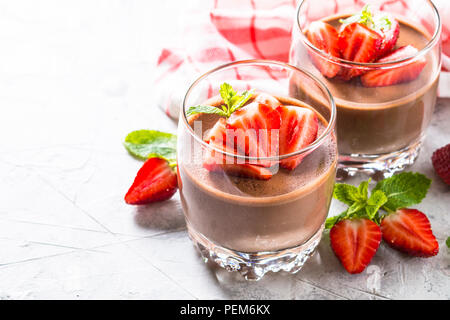 Chocolate dessert of whipped cream and strawberries in glass. Stock Photo