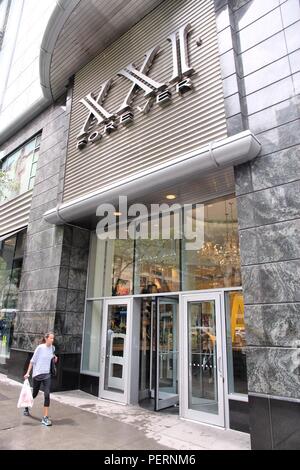 CHICAGO, USA - JUNE 26, 2013: Shopper walks by Forever 21 fashion store at Magnificent Mile in Chicago. The Magnificent Mile is one of most prestigiou Stock Photo