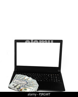 Laptop or notebook with widespread of cash one hundred dollar bills isolated on white background with clean blank display. Template, mock up. Stock Photo