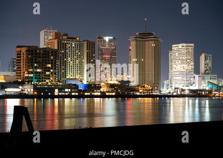 Cloudy skies start to clear after a storm making a rainbow behind the buildings of New Orleans Louisiana Stock Photo