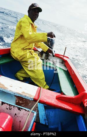 Vila do Maio ,Maio Island, Cape Verde - Jan 5 2016: local fisherman going out to sea to fish for yellow fin tuna or wahoo in a traditional colorful di Stock Photo