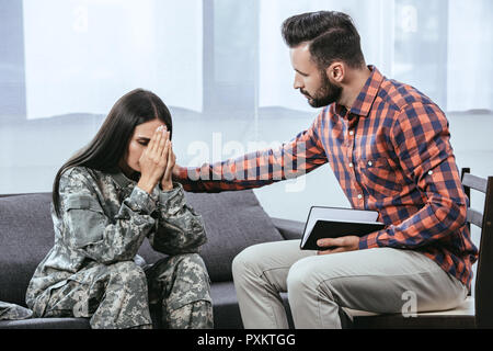 Female psychologist supporting male soldier at office Stock Photo - Alamy