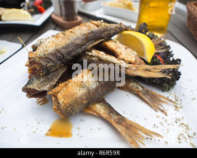 Fried herring, a common dish in the coastal regions around the baltic sea, here on a plate in a restaurant in Gdansk Poland Stock Photo