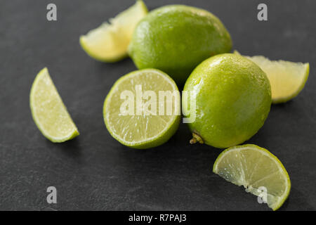 close up of limes on slate table top Stock Photo