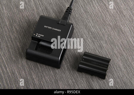 close up of Lithium ion battery and charger for digital camera Stock Photo