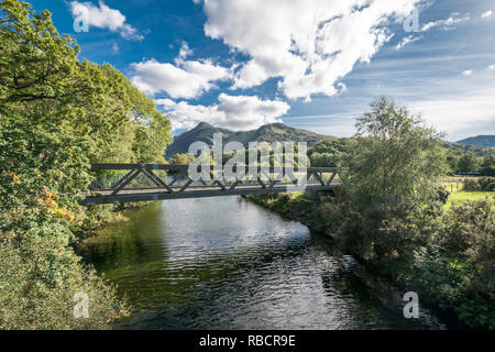 Llyn Padarn Country Park joining river for the two lakes at Llanberis in North Wales view towards Snowdon Yr Wyddfa mountain Stock Photo