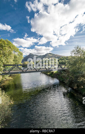 Llyn Padarn Country Park joining river for the two lakes at Llanberis in North Wales view towards Snowdon Yr Wyddfa mountain Stock Photo