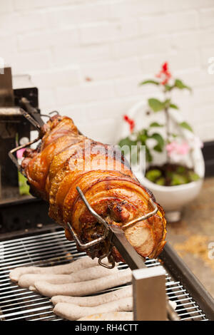 Pork being roasted on spit in English Pub Stock Photo