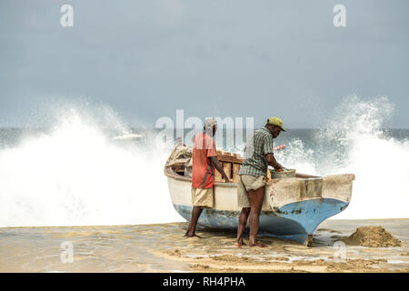 Cape Verde, Maio Island: fishermen close to barges on the beach of Porto Ingles (Vila do Maio) Stock Photo