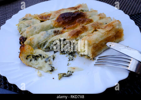 Bosnian rolled spinach and cheese borek at the Bascarsija bazaar in Sarajevo, Bosnia and Herzegovina. Stock Photo