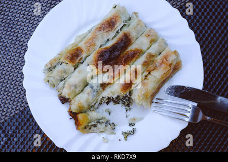 Bosnian rolled spinach and cheese borek at the Bascarsija bazaar in Sarajevo, Bosnia and Herzegovina. Stock Photo