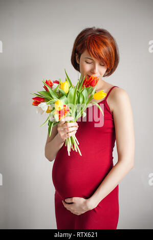 pregnant woman holding her belly / 8th month Stock Photo - Alamy