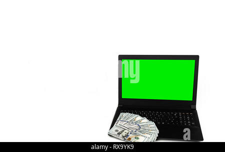 Horizontal shot of laptop or notebook with widespread of dollar cash money isolated on white background with green screen display template mock up Stock Photo