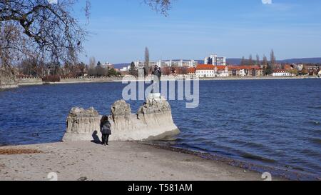 Tata Hungary 03 04 2017 tourists photograph the sacred statue of the holy George in Lake Tata Stock Photo