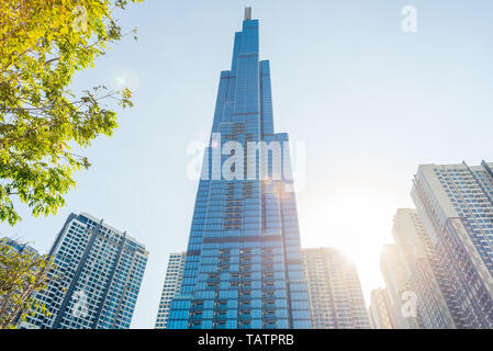 Ho Chi Minh City, Vietnam - February 19, 2019: Landmark 81 and other Vinhomes Central Park high-rise buildings, with the sun shining and lens flares. Stock Photo