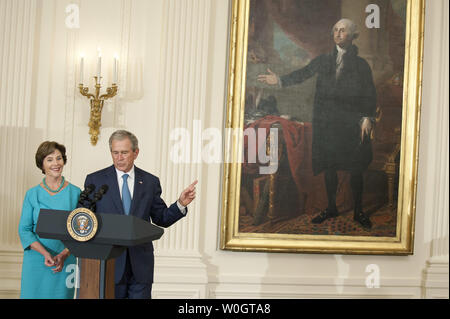 Former President George W. Bush and his wife Laura deliver remarks at the unveiling ceremony for his White House portrait in the East Room at the White House in Washington on May 31, 2012.  UPI/Kevin Dietsch Stock Photo