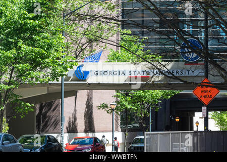 Atlanta, USA - April 20, 2018: Georgia State University urban city campus with building hall sign and students walking in summer Stock Photo