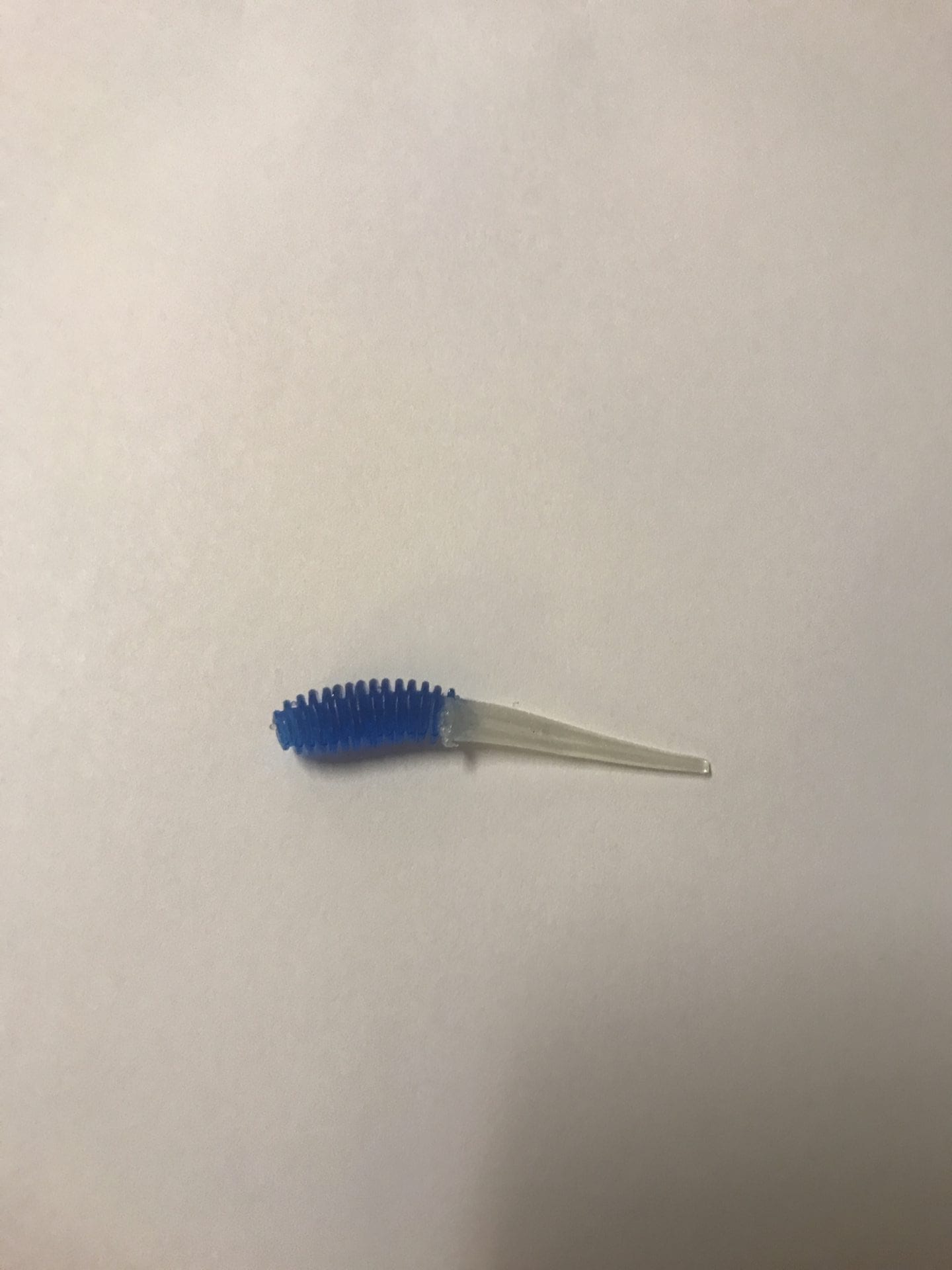 A blue brush is on the wall