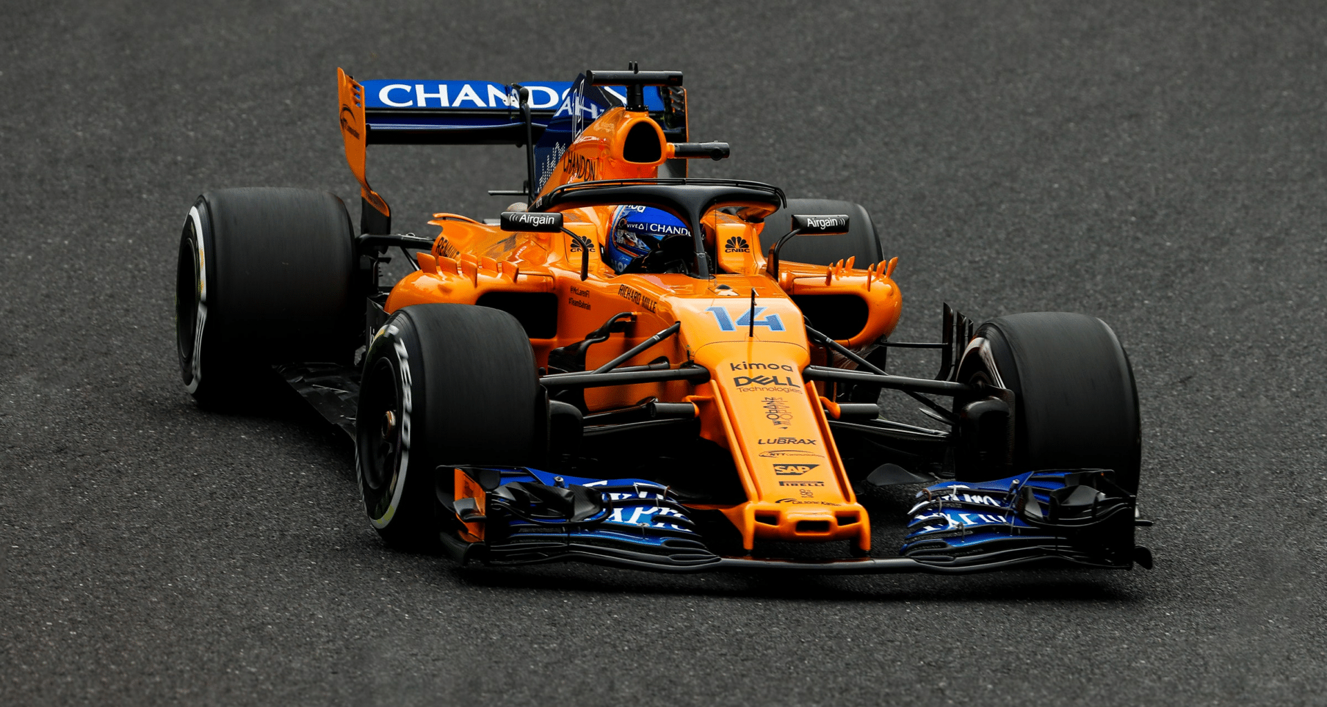 a man driving a race car on a race track