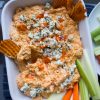 Buffalo Chicken Dip in a white casserole dish