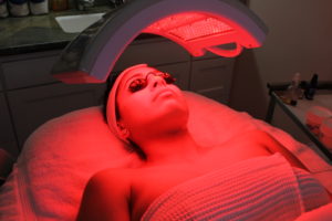 A woman is getting her skin red in the sun.