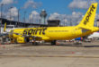 a yellow airplane on a runway