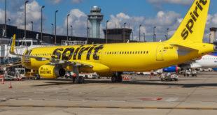 a yellow airplane on a runway