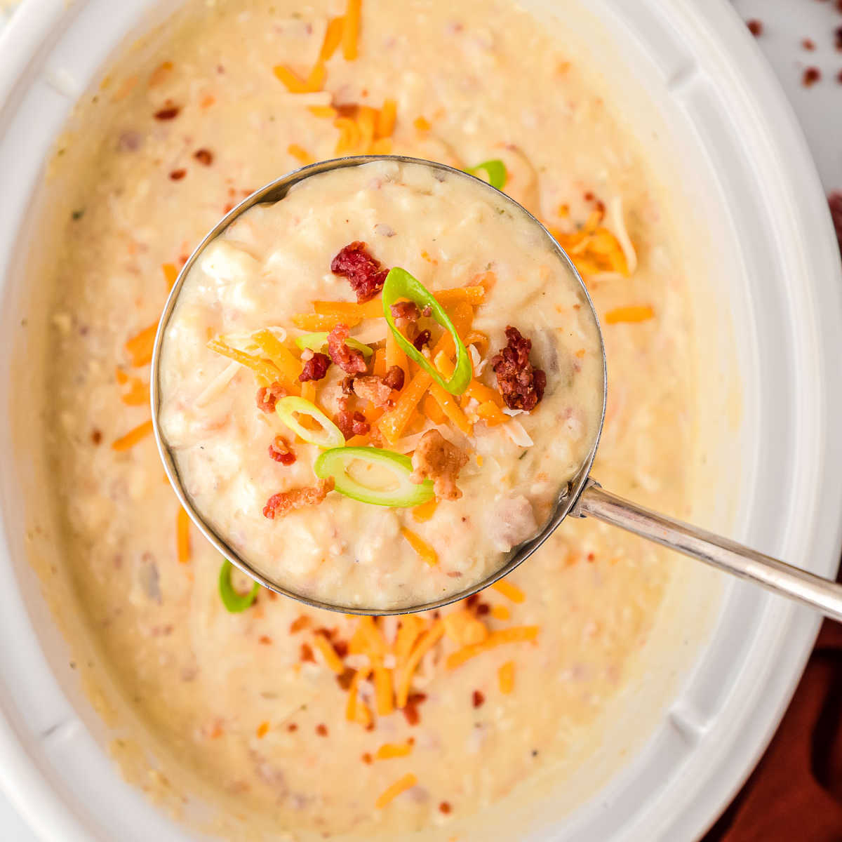 soup in a ladle over a pot