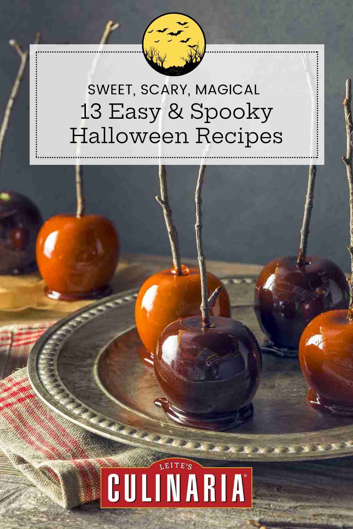 Caramel apples on a silver tray with wooden branches as handles.