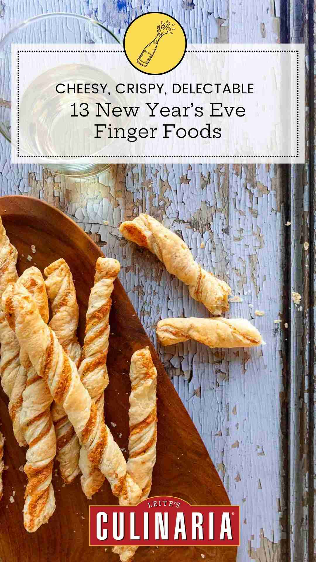 Cheese straws on an oval wooden platter on a distressed wooden surface.