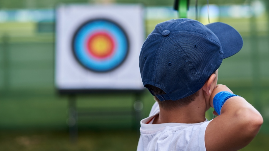 A child practising archery.