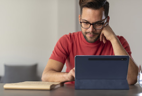 hombre con camisa roja mirando un tablet