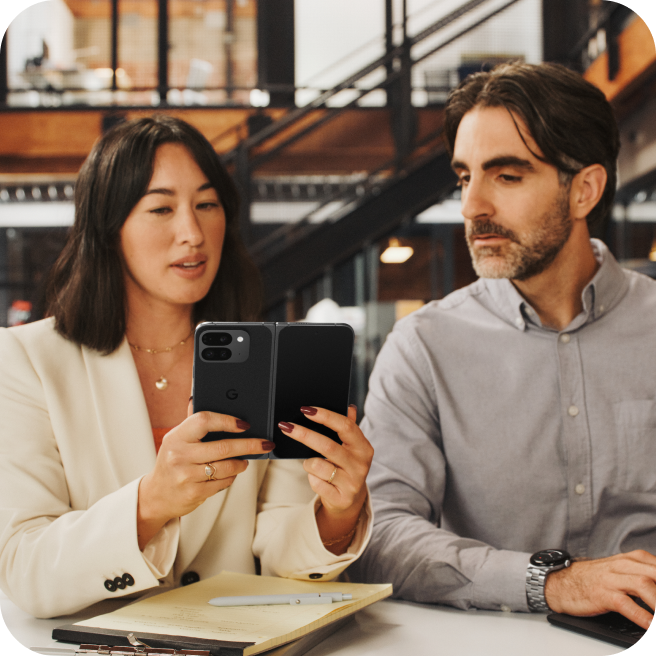 Two co-workers working on a Google Pixel 9 Pro Fold phone.