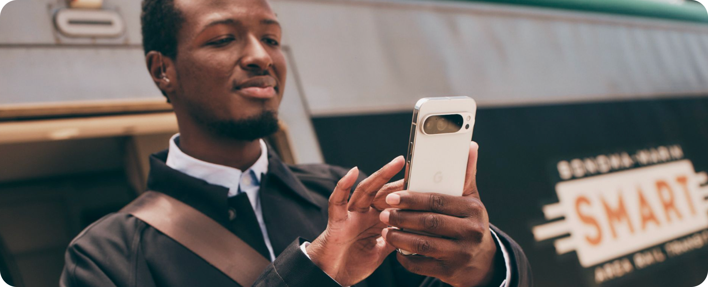 A man working on his Google Pixel 9 Pro XL phone on the go.