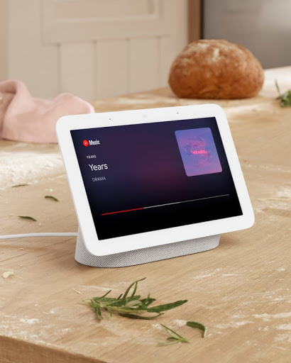 Nest Hub on table with fresh bread in background.