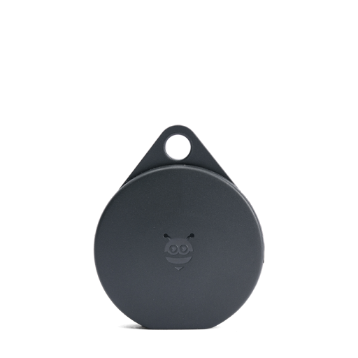 A circular, black tracking tag device.