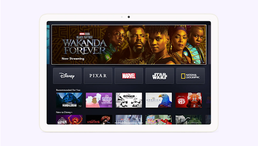 A tablet displaying the Disney+ homepage featuring recommended shows and movies.