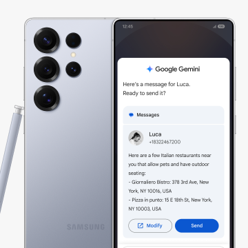 A Samsung Galaxy S25 Ultra is positioned facing backward with a stylus pen resting against it. Beside it, another phone faces forward, displaying a message to Luca about Italian restaurants. Above it reads: "Here's a message for Luca. Ready to send it?”