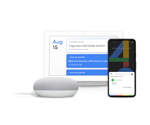 A Google Home, laptop, and phone featuring Hey Google