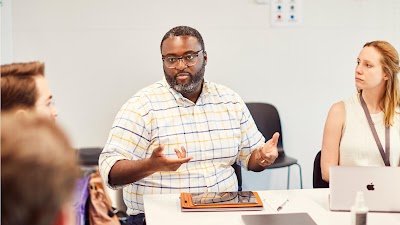 A man explaining something to his colleagues.