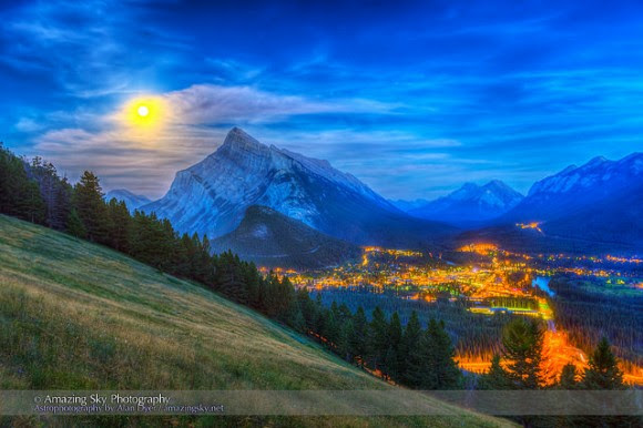 The supermoon of August 10, 2014 rising behind Mt. Rundle and Banff, Alberta, Canada as shot from the Mt. Norquay viewpoint looking south over the valley. Credit and copyright: Alan Dyer. 