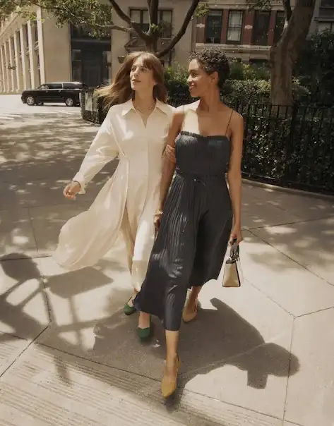 Two women walking in a metropolitan area in the afternoon.