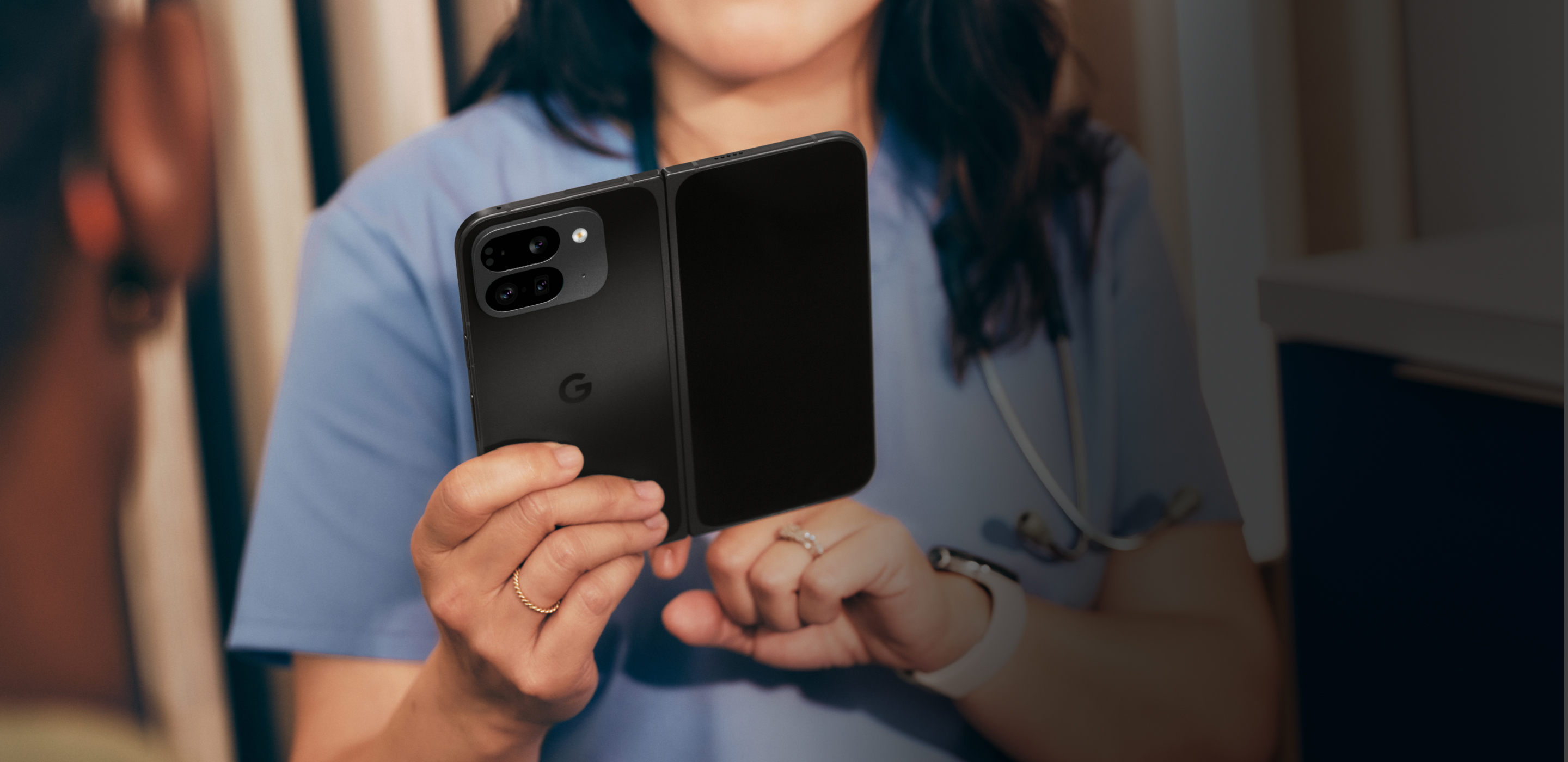 A man using a Google Pixel 7a phone in his office.